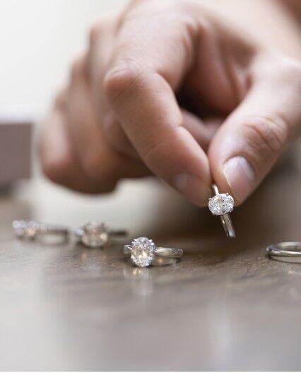 Platinum engagement ring with 0.74ct oval diamond with side